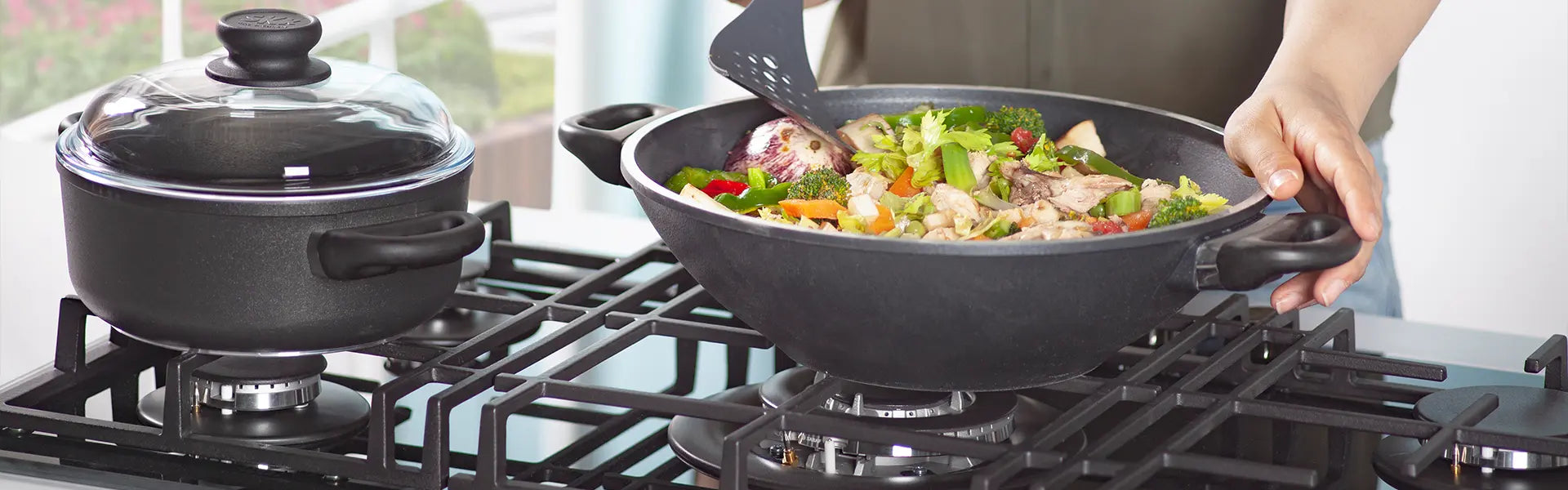 Wok auf einem Gasherd mit buntem Gemüse und Fleisch, perfekt für asiatische Gerichte.